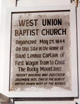 A historical sign attached to the front of the church.